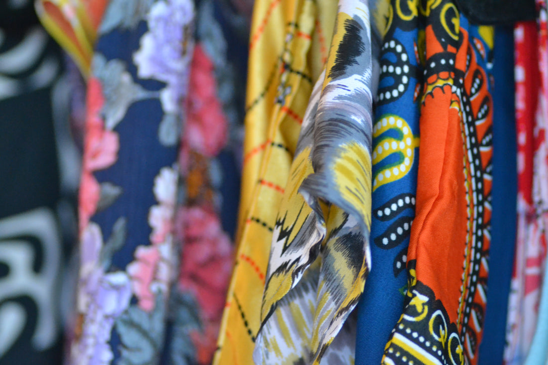  Image shows a close up of a rack with colorful fabrics